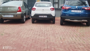 Three cars parked in front of a building with a tiled roof and a sign that reads "ADT Armed Security". - Room-home of Peace and Tranquility (Pretoria)
