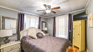 A bedroom with a bed, nightstands, a ceiling fan, and a wardrobe. - < 1 Mi to Fishing: Springville Home w/ Fireplace! (Springville)