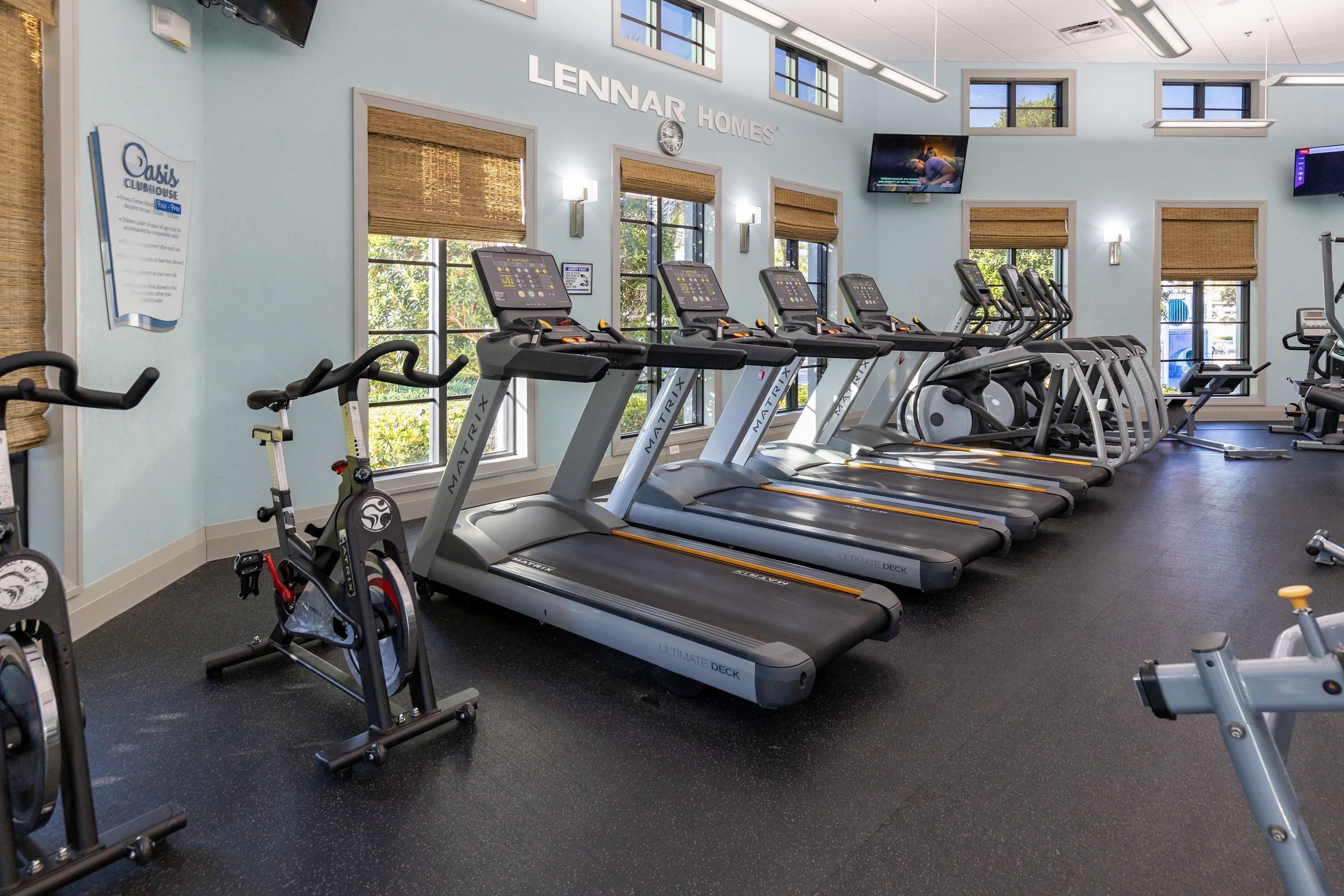 A gym with treadmills, stationary bikes, and weight machines.