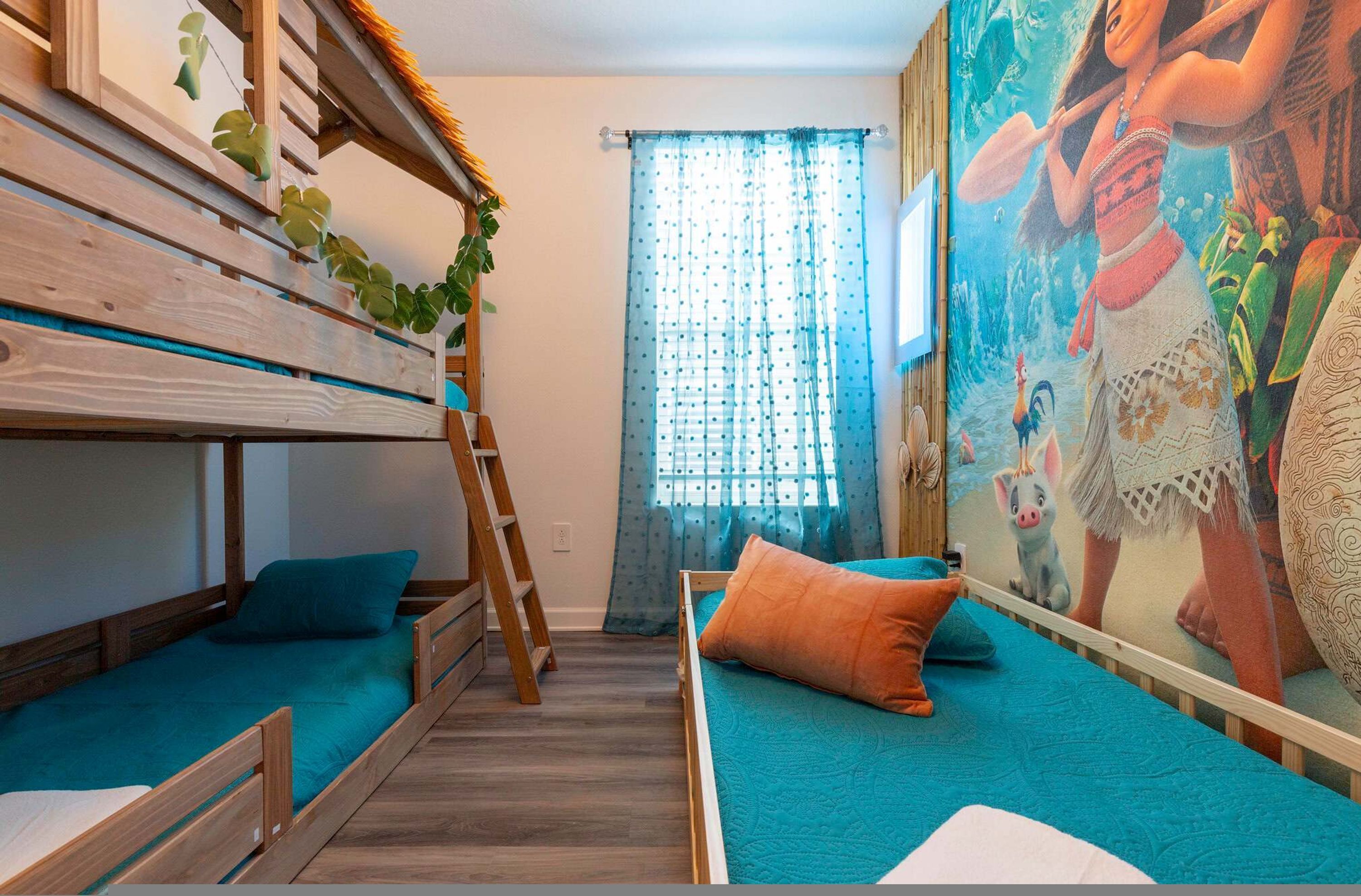 A room with a bunk bed, a ladder, a window with curtains, and a mural on the wall.