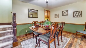 A dining area with a wooden table, chairs, a ceiling fan, and a staircase. - Grill, Dine & Relax Outside: Home in Tyrone! (Tyrone)