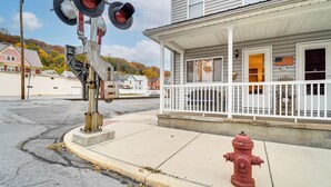 A street with a traffic signal, a fire hydrant, and a building with a porch. - Grill, Dine & Relax Outside: Home in Tyrone! (Tyrone)