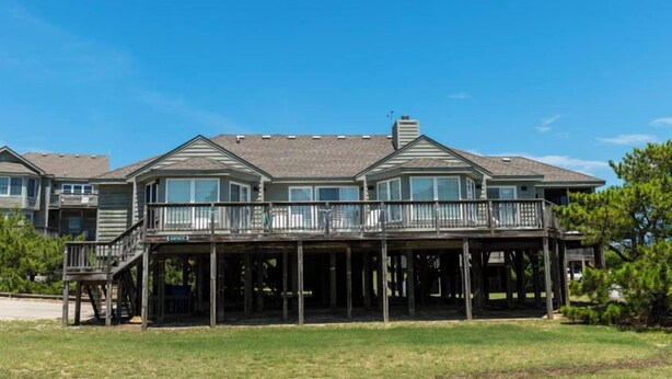 A two-story house with a balcony and a covered porch. - Earnest, Ships Watch Community in Duck, NC (Duck)