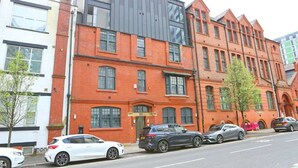 A modern building with a brick facade and large windows. - Beautifully 3Bed Restored Apartment near Deansgate - Pass the Keys (Salford)