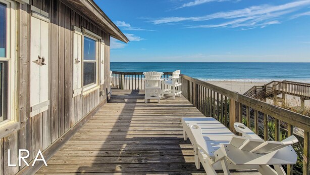 A wooden deck with lounge chairs overlooking a beach. - Beachy McBeach House: Bold, Bright & Beachy (Surf City)