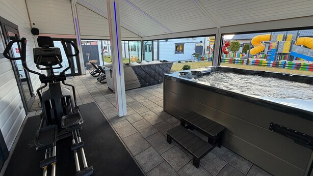 A gym with exercise equipment, a hot tub, and a view of a playground. - Holiday homes close to the beach, air conditioning (Sianozety)