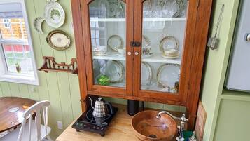 Oven, coffee/tea maker, cookware/dishes/utensils, dining tables