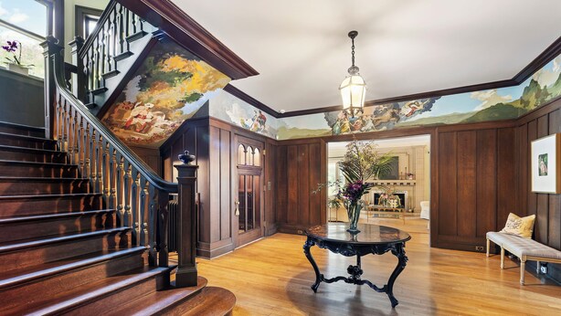 A grand staircase with a wooden finish, a round table with a vase, and a mural on the ceiling. - Historic Manor House Private Guest Suite Evanston (Evanston)