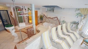 A spa area with a reception desk, a large bathtub, and several striped lounge chairs. - Apartment in Pitztal Near Ski Slopes (Arzl im Piztal)