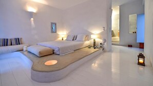A modern bedroom with a bed, bedside tables, a sofa, and a small rug. - Villa Irina - Five Bedroom Villa, Sleeps 10 (Makria Miti)