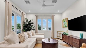 A modern living room with a sofa, coffee table, and TV.