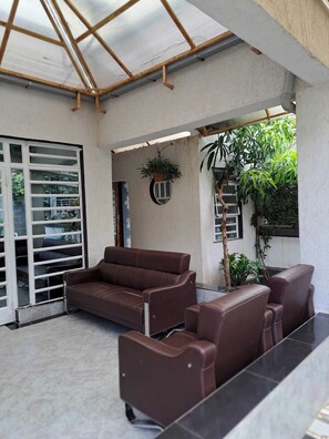 Family Townhome, Garden View | Living area | 64-inch Smart TV with digital channels - Rofty Vacation Home Utawala (Nairobi)