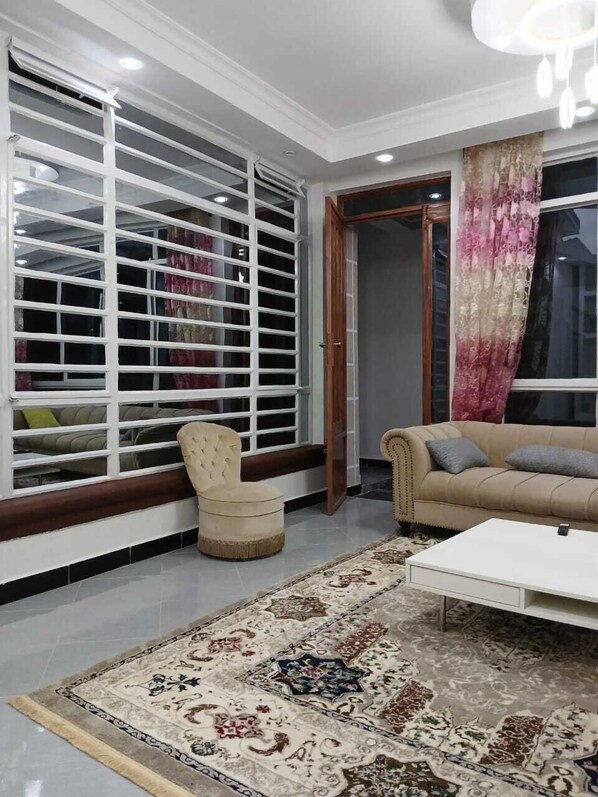 Family Townhome, Garden View | Living area | 64-inch Smart TV with digital channels - Rofty Vacation Home Utawala (Nairobi)