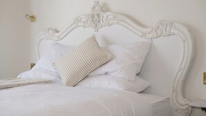 A bed with a white headboard and multiple pillows. - The Stella Historic Llandudno B&B (Llandudno)