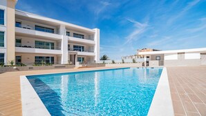 A modern multi-story building with a swimming pool in front. - LAGOS MARINA VIEW 3 WITH POOL by HOMING (Lagos)