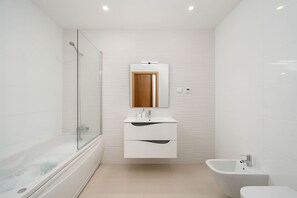 A modern bathroom with a glass-enclosed shower, a vanity with a mirror, and a bidet. - LAGOS MARINA VIEW 3 WITH POOL by HOMING (Lagos)