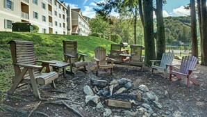 Outdoor seating with Adirondack chairs and a fire pit.