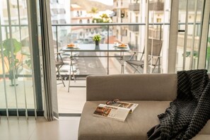 A modern living room with a sofa, a magazine, and a blanket. - The Korner Adeje Renovated Flat (Adeje)