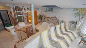 A spa area with a reception desk, a large bathtub, and several striped lounge chairs. - Apartment in Wald Near Hochzeiger Ski Area (Arzl im Piztal)