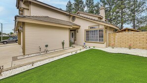 A two-story house with a garage, a front lawn, and a brick wall. - 2 Mi to Victoria Gardens: Rancho Cucamonga Haven (Rancho Cucamonga)