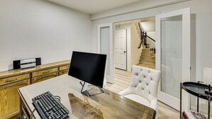 A modern living room with a flat-screen TV, a glass-top coffee table, a white leather armchair, and a wooden cabinet. - 2 Mi to Victoria Gardens: Rancho Cucamonga Haven (Rancho Cucamonga)