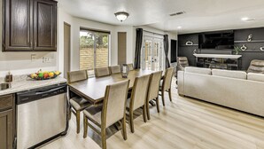 A modern kitchen with a dining area, a sofa, and a TV. - 2 Mi to Victoria Gardens: Rancho Cucamonga Haven (Rancho Cucamonga)