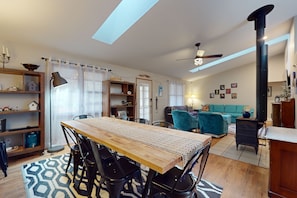 Cozy living space with a central dining table, comfortable sofa, and fireplace.