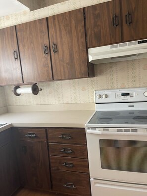Enjoy cooking in this well-equipped kitchen with a modern stove and ample countertop space.