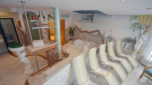 A spa area with a reception desk, a large bathtub, and several striped lounge chairs. - Apartment in Pitztal With Mountain Views (Arzl im Piztal)