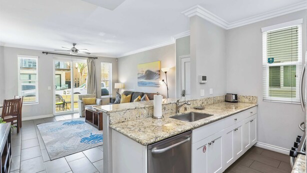 A modern kitchen with granite countertops, stainless steel appliances, and a view to the outside. - Newport Beach Retreat Steps to Sand, Boardwalk and Pier (Newport Beach)