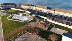 A large hotel with multiple buildings, a parking lot, and a playground area. - Happy Haven @ Lands End – 3 BDR Resort Condo! (Osage Beach)