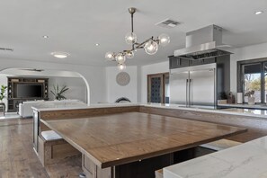 Enjoy casual dining and ample workspace in this kitchen with a large island and appliances.