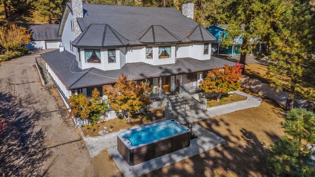 A two-story house with a stone chimney, a covered porch, and a swimming pool. - Luxary Castle & SPA near Skiing Resort (Wrightwood)