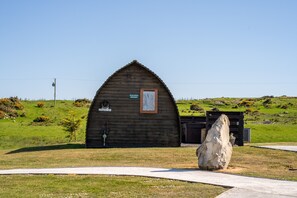 A wooden cabin with a sign reading "Highland Heritage."