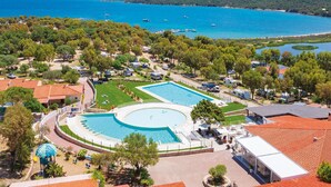 A resort with a large swimming pool, beach access, and a view of the sea. - Camping Village Capo d'Orso by Interhome (Palau)