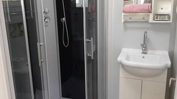 Shower, towels, soap, toilet paper