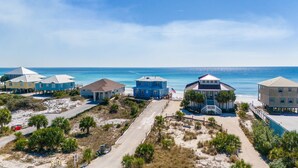 A coastal property with multiple beach houses, a sandy driveway, and a clear view of the ocean. - Private Beach | Exclusive 4BR Dune Allen (Santa Rosa Beach)