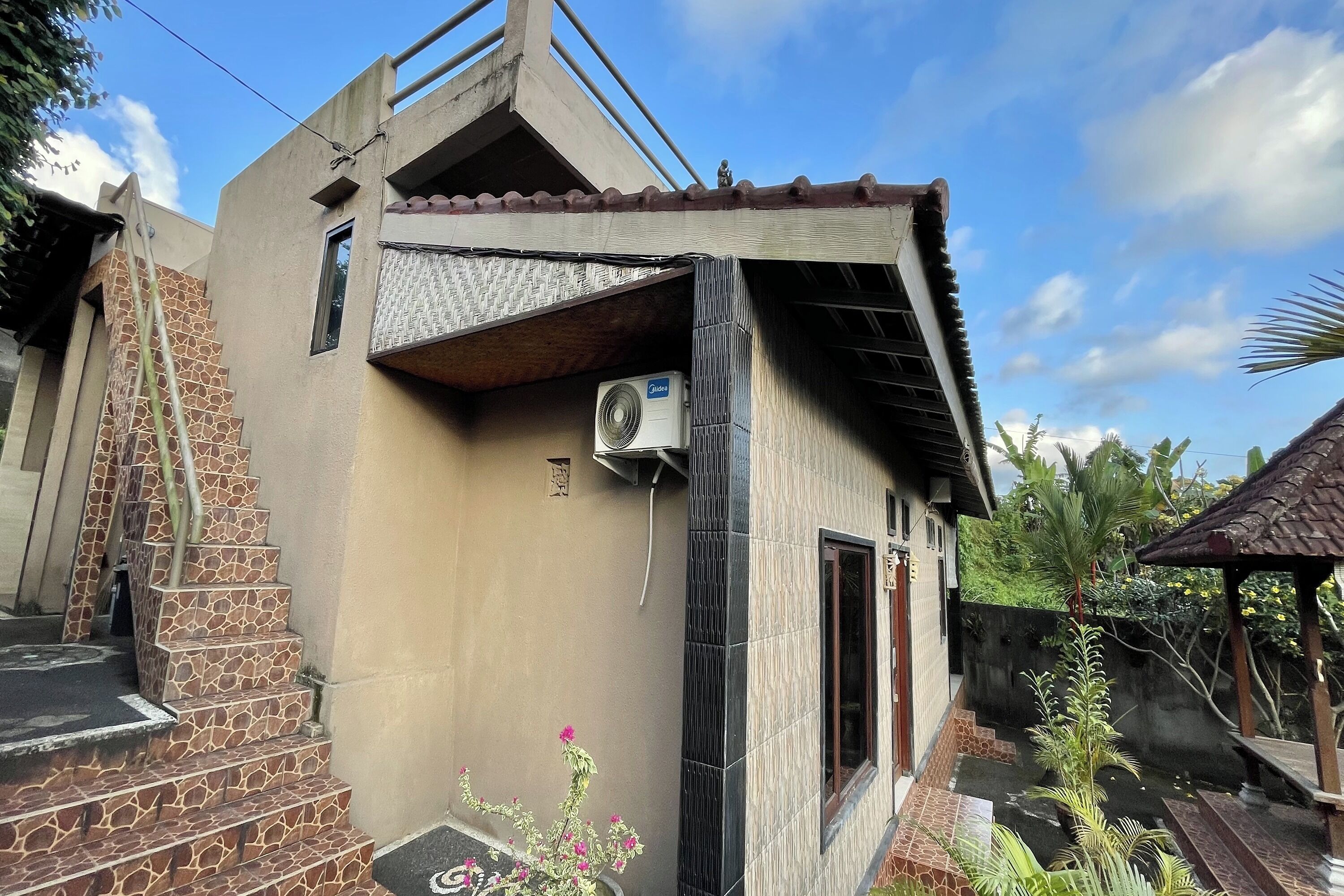 A building with a unique architectural design, including a sloped roof and a small balcony.