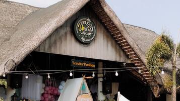 A building with a thatched roof and a sign reading "Leovita Pavilion".