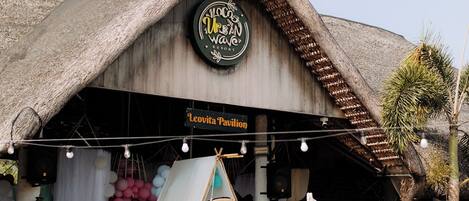 A building with a thatched roof and a sign reading "Leovita Pavilion".