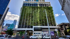 A modern building with a vertical garden facade, a 'Platinum' sign, and a '45 Clarke Street' address.
