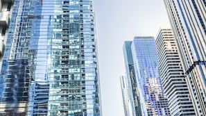 A high-rise urban building with reflective glass facades and a modern architectural design.