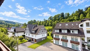 A residential area with houses featuring gabled roofs and a mix of modern and traditional architecture. - A comfortable and versatile room—perfect for relaxation, work, and socializing (Winterberg)
