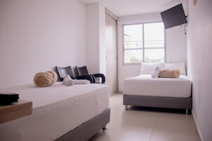 Deluxe Quadruple Room | Hypo-allergenic bedding, laptop workspace, free WiFi, bed sheets