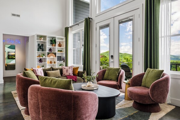 A modern living room with a sofa set, a coffee table, and a bookshelf.