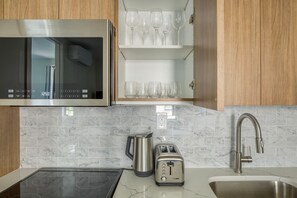 Fridge, microwave, oven, stovetop - Clean East Village 1BR w/ Rooftop Pool, Gym, W/D, A/C, by Blueground (Downtown)