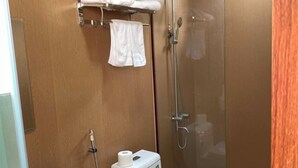A compact bathroom with a toilet, sink, and shower. - PV BEACH BUNGALOW (Phu Quoc)