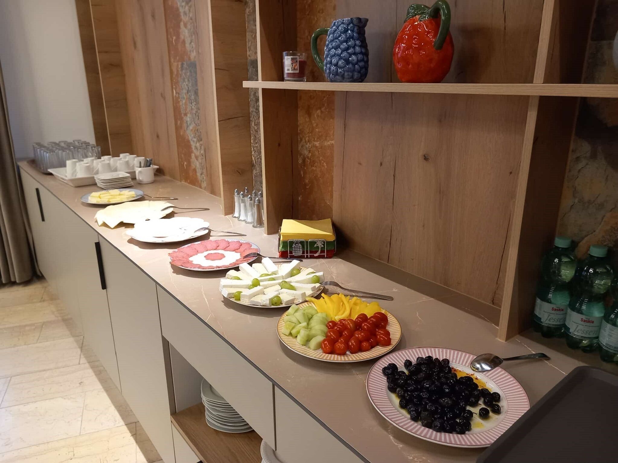 A buffet setup with various food items and condiments.