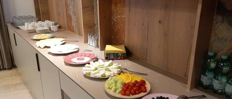A buffet setup with various food items and condiments.