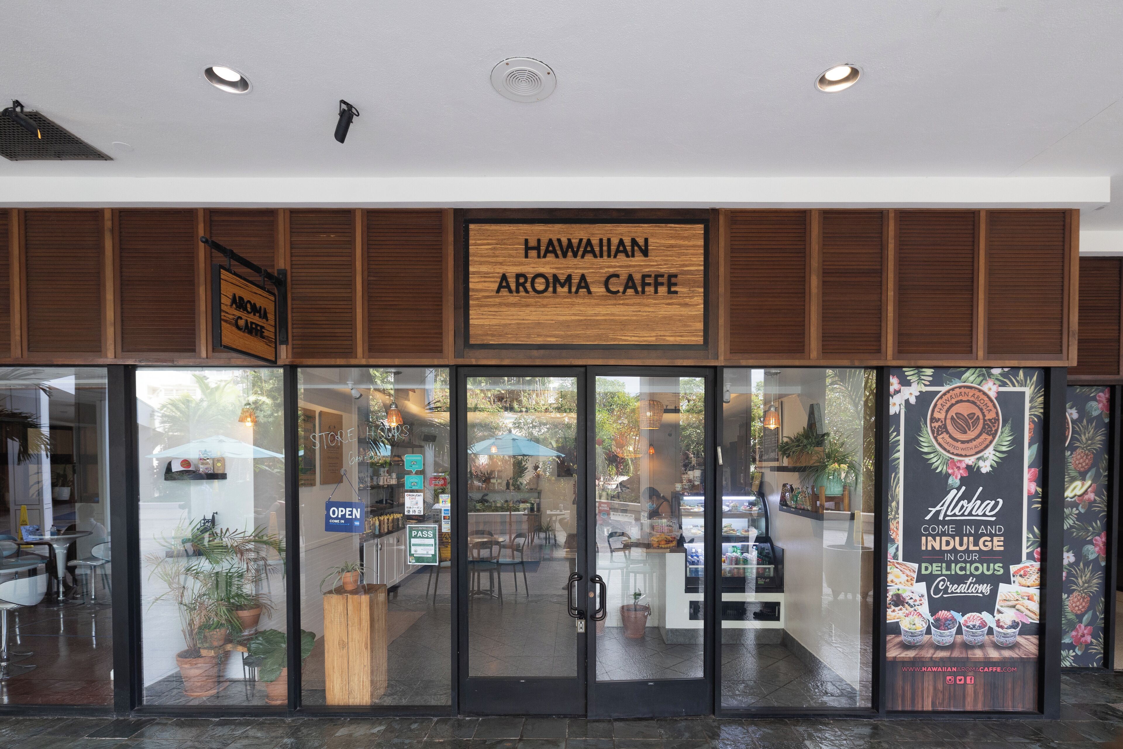 A storefront with a sign reading "HAWAIIAN AROMA CAFFE".